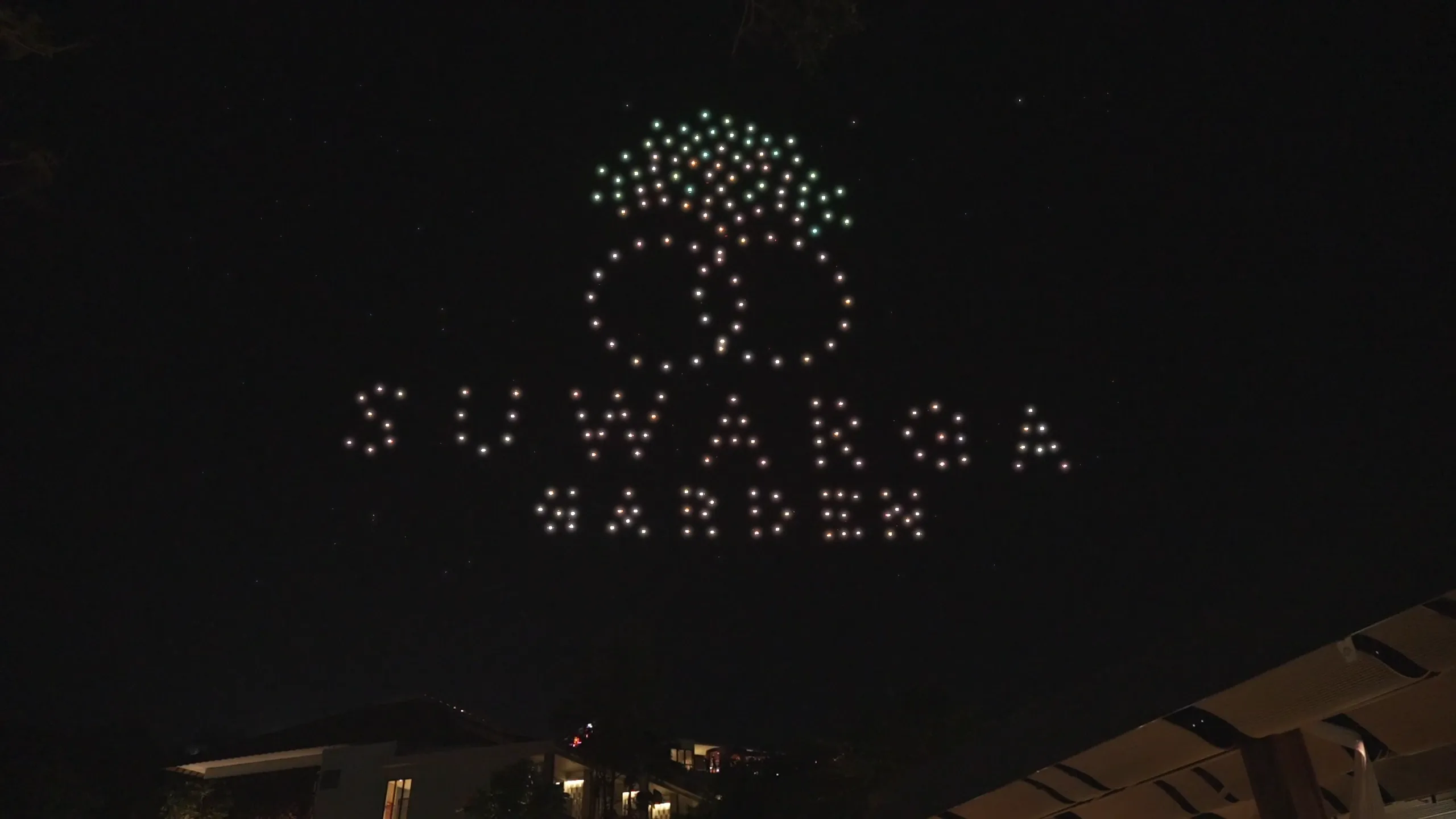 Logo Suwarga Garden dari cahaya drone, dilihat dari area garden Mövenpick Jimbaran Bali.